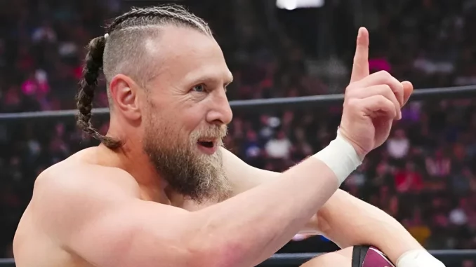 Bryan Danielson sitz im Ring und zeigt mit dem Finger nach oben