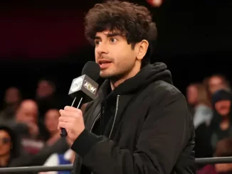 Tony Khan hält für seine Rede ein Mikrofon in der Hand