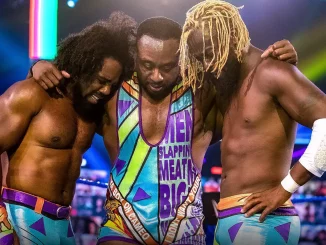 Big E, Kofi Kingston und Xavier Woods stehen als The New Day gemeinsam im WWE-Ring und legen emotional die Arme umeinander