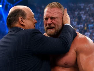 Paul Heyman steht im Ring und hält Brock Lesnars Kopf