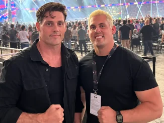 Stings Söhne posieren gemeinsam vor der Kamera in einer gut gefüllten Wrestling-Arena, während im Hintergrund zahlreiche Zuschauer, Sitzreihen und die hell beleuchtete Showbühne zu sehen sind